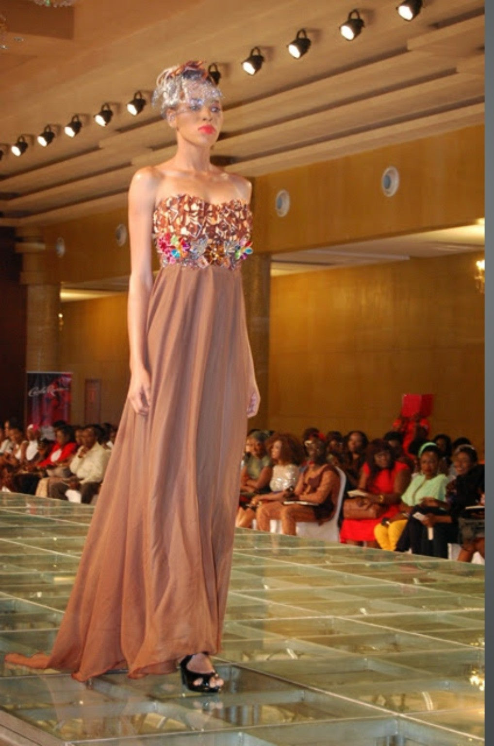 Tolumi runway look in a neutral floor-length gown