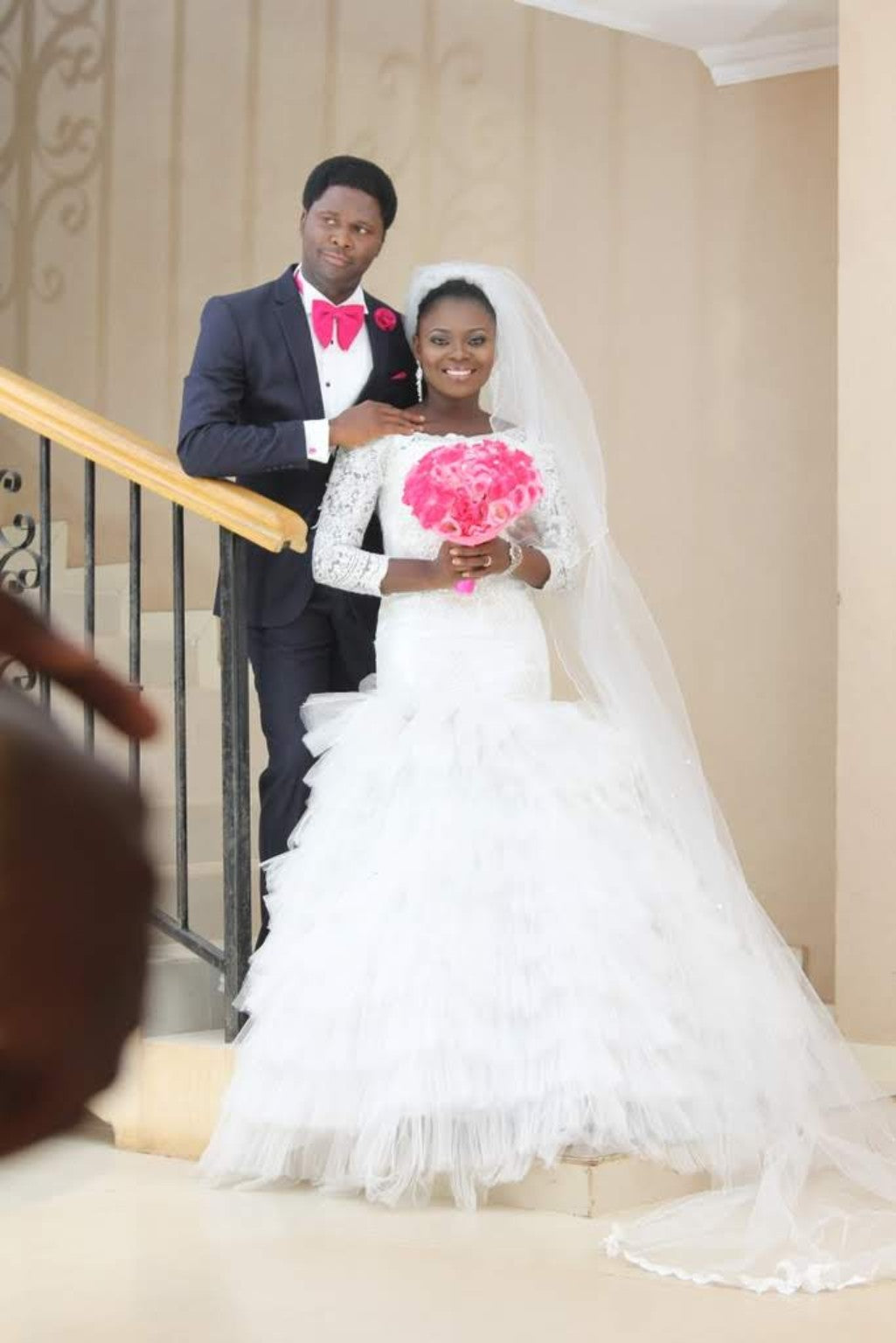 Bride in a white tiered wedding gown with groom