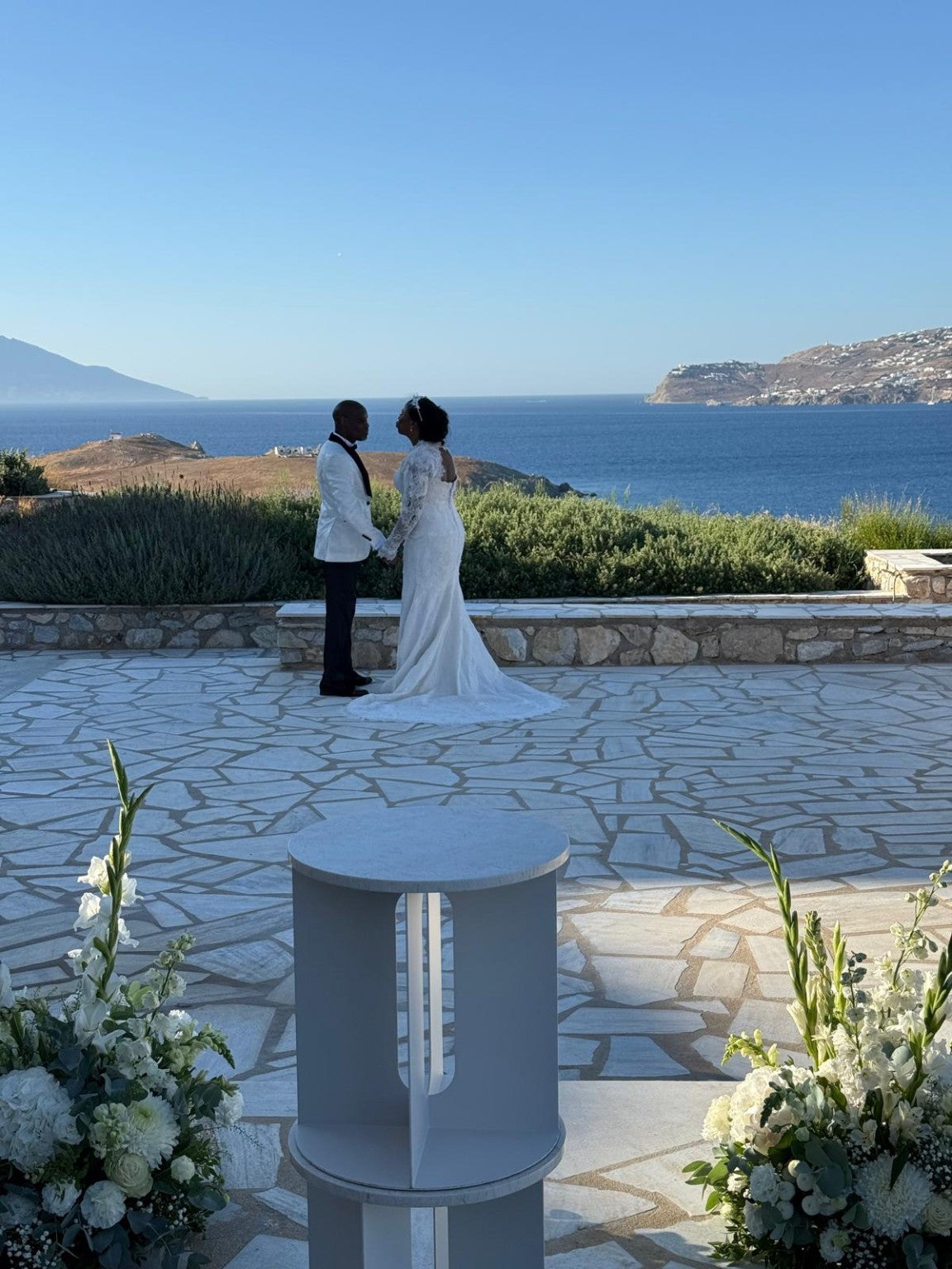 Wide view of bride and groom at a seaside wedding