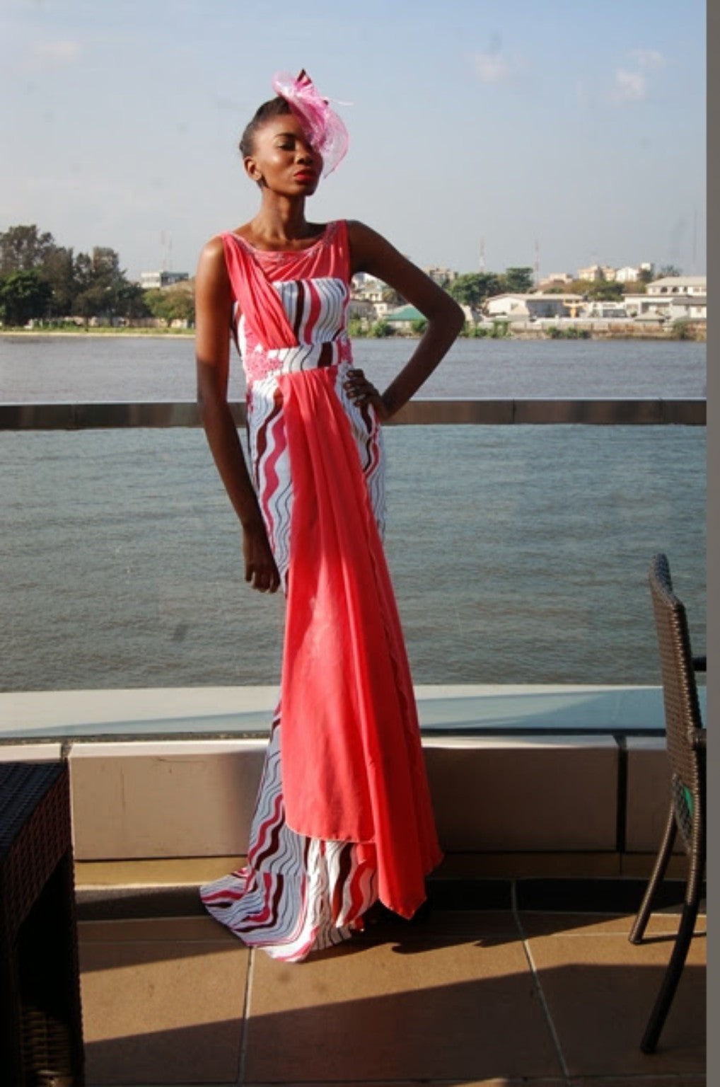Coral and white floor-length fashion look photographed by the waterfront