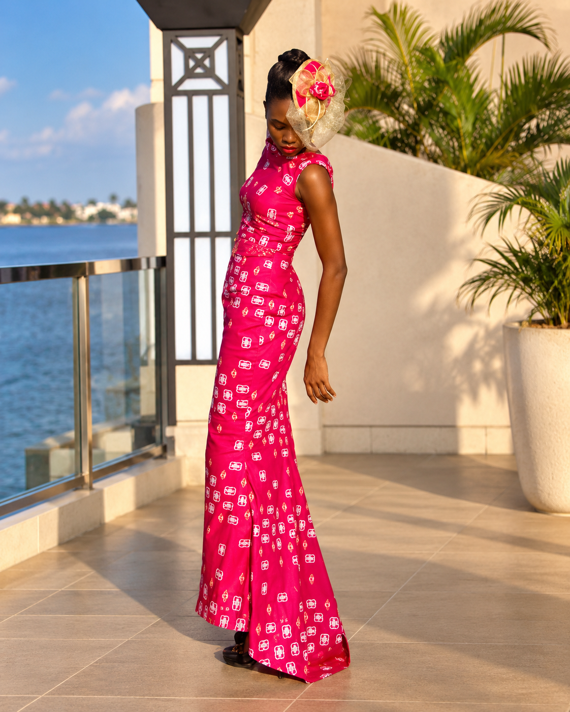 Model in a fuchsia floor-length gown by the waterfront