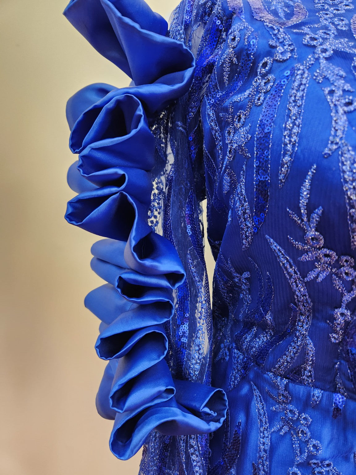 Close detail of blue couture ruffle and embellished fabric