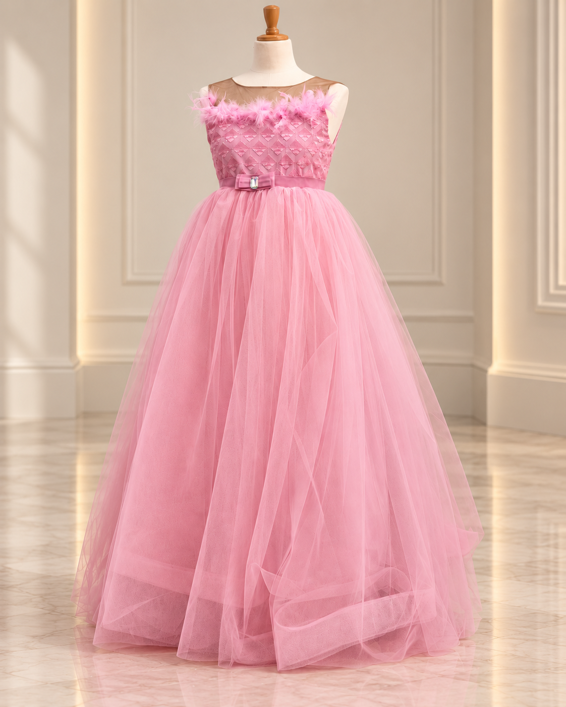 Pink tulle occasion ball gown on mannequin in a clean atelier setting